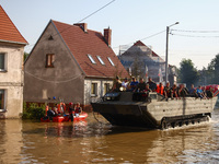 Residents are being evacuated by emergency workers on a military amphibious vehicle after Nysa Klodzka river flooded town of Lewin Brzeski i...