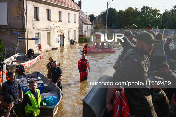 Residents are being evacuated by emergency workers after Nysa Klodzka river flooded town of Lewin Brzeski in southwestern Poland, on Septemb...