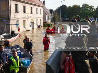 Residents are being evacuated by emergency workers after Nysa Klodzka river flooded town of Lewin Brzeski in southwestern Poland, on Septemb...