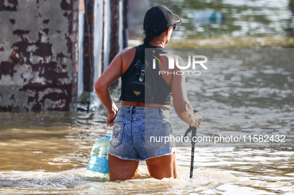 A resident is seen walking in a water after Nysa Klodzka river flooded town of Lewin Brzeski in southwestern Poland, on September 17th, 2024...