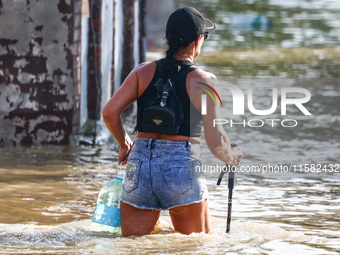 A resident is seen walking in a water after Nysa Klodzka river flooded town of Lewin Brzeski in southwestern Poland, on September 17th, 2024...