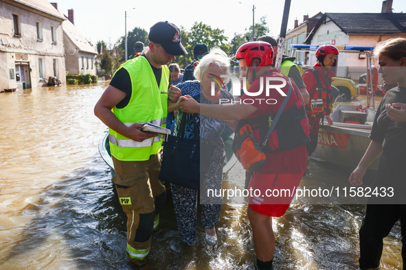 Residents are being evacuated by emergency workers after Nysa Klodzka river flooded town of Lewin Brzeski in southwestern Poland, on Septemb...