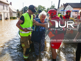 Residents are being evacuated by emergency workers after Nysa Klodzka river flooded town of Lewin Brzeski in southwestern Poland, on Septemb...