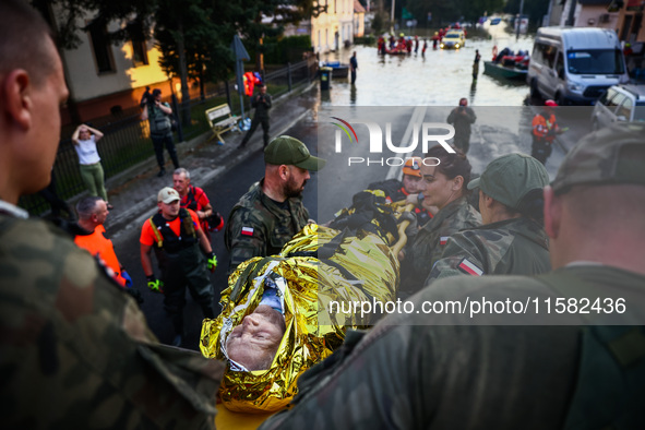 Residents are being evacuated by emergency workers after Nysa Klodzka river flooded town of Lewin Brzeski in southwestern Poland, on Septemb...