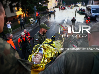 Residents are being evacuated by emergency workers after Nysa Klodzka river flooded town of Lewin Brzeski in southwestern Poland, on Septemb...