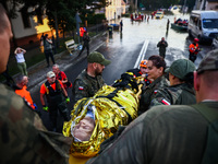 Residents are being evacuated by emergency workers after Nysa Klodzka river flooded town of Lewin Brzeski in southwestern Poland, on Septemb...