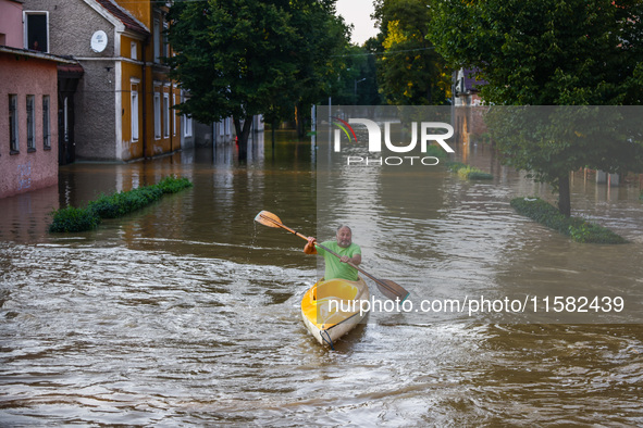 A resident swims in a canoe after Nysa Klodzka river flooded town of Lewin Brzeski in southwestern Poland, on September 17th, 2024. Storm Bo...