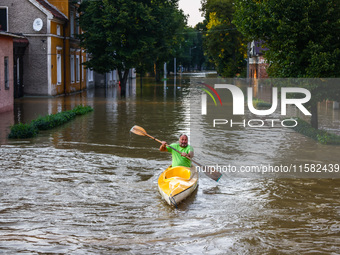 A resident swims in a canoe after Nysa Klodzka river flooded town of Lewin Brzeski in southwestern Poland, on September 17th, 2024. Storm Bo...