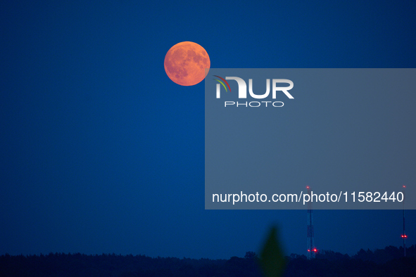 The Harvest Moon full moon is seen in the night sky over Frankfurt an der Oder, Germany on 17 September, 2024. 