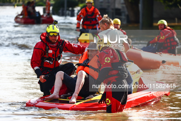 Residents are being evacuated by emergency workers after Nysa Klodzka river flooded town of Lewin Brzeski in southwestern Poland, on Septemb...