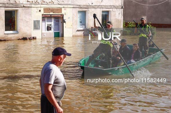 Residents are being evacuated by emergency workers after Nysa Klodzka river flooded town of Lewin Brzeski in southwestern Poland, on Septemb...