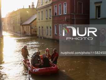 Residents are being evacuated by emergency workers after Nysa Klodzka river flooded town of Lewin Brzeski in southwestern Poland, on Septemb...