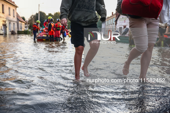 Residents walk away after being evacuated after Nysa Klodzka river flooded town of Lewin Brzeski in southwestern Poland, on September 17th,...