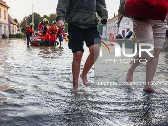 Residents walk away after being evacuated after Nysa Klodzka river flooded town of Lewin Brzeski in southwestern Poland, on September 17th,...