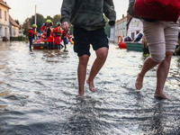 Residents walk away after being evacuated after Nysa Klodzka river flooded town of Lewin Brzeski in southwestern Poland, on September 17th,...