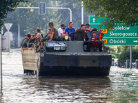 Residents are being evacuated on a military amphibious vehicle by emergency workers after Nysa Klodzka river flooded town of Lewin Brzeski i...