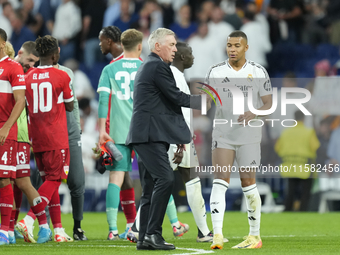 Carlo Ancelotti head coach of Real Madrid and Kylian Mbappe centre-forward of Real Madrid and France celebrate victory after the UEFA Champi...