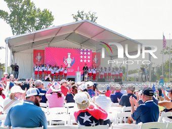 GAINESVILLE, VIRGINIA - SEPTEMBER 15: Sports commentator Grant Boone speaks as members of Team USA  and their caddies, including Sarah Schme...