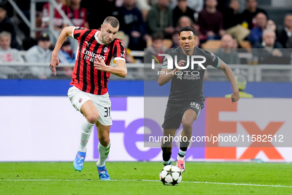 Strahinja Pavlovic of AC Milan and Trent Alexander-Arnold of Liverpool FC compete for the ball during the UEFA Champions League 2024/25 Leag...