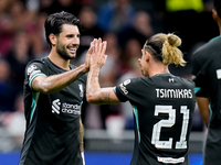 Dominik Szoboszlai of Liverpool FC celebrates with Kostas Tsimikas after scoring third goal during the UEFA Champions League 2024/25 League...