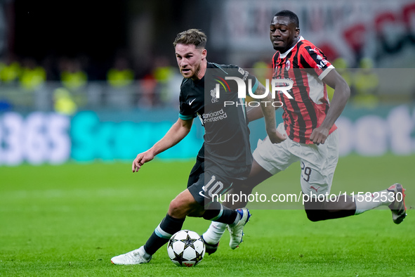 Youssouf Fofana of AC Milan and Alexis Mac Allister of Liverpool FC compete for the ball during the UEFA Champions League 2024/25 League Pha...