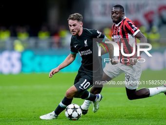 Youssouf Fofana of AC Milan and Alexis Mac Allister of Liverpool FC compete for the ball during the UEFA Champions League 2024/25 League Pha...