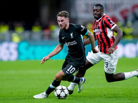 Youssouf Fofana of AC Milan and Alexis Mac Allister of Liverpool FC compete for the ball during the UEFA Champions League 2024/25 League Pha...