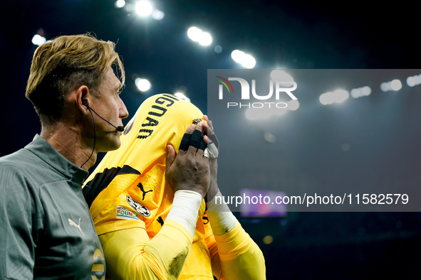 Mike Maignan of AC Milan leaves the pitch injured during the UEFA Champions League 2024/25 League Phase MD1 match between AC Milan and Liver...