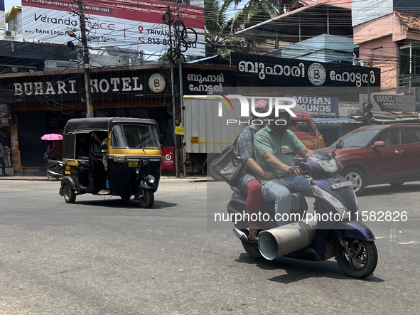 A man carries a large pipe on his scooter in Thiruvananthapuram (Trivandrum), Kerala, India, on April 2, 2024. 