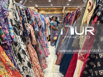 Women shop for designer churidars at a textile shop in Thiruvananthapuram, Kerala, India, on April 10, 2024. (