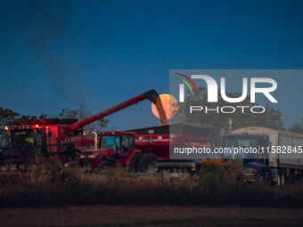 A Super Moon rises over a soybean harvest at Malkow Farms in Monroe, Wisconsin, on September 17, 2024. The full moon, known as the Harvest M...