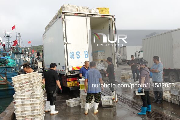 Citizens buy various kinds of seafood unloaded at Jimiya fishing Port in the West Coast New Area in Qingdao, China, on September 18, 2024. 