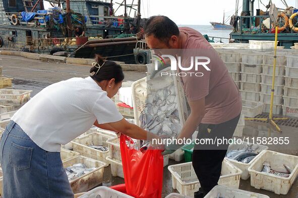 Citizens buy various kinds of seafood unloaded at Jimiya fishing Port in the West Coast New Area in Qingdao, China, on September 18, 2024. 