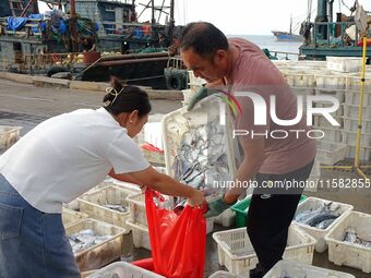 Citizens buy various kinds of seafood unloaded at Jimiya fishing Port in the West Coast New Area in Qingdao, China, on September 18, 2024. (