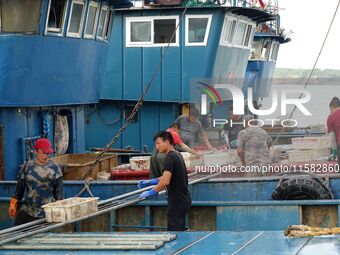 Citizens buy various kinds of seafood unloaded at Jimiya fishing Port in the West Coast New Area in Qingdao, China, on September 18, 2024. (