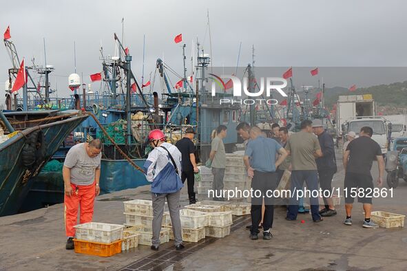 Citizens buy various kinds of seafood unloaded at Jimiya fishing Port in the West Coast New Area in Qingdao, China, on September 18, 2024. 