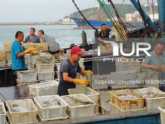 Citizens buy various kinds of seafood unloaded at Jimiya fishing Port in the West Coast New Area in Qingdao, China, on September 18, 2024. (