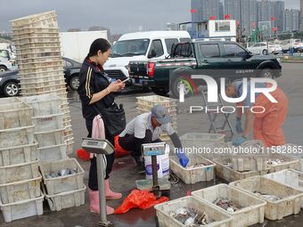 Citizens buy various kinds of seafood unloaded at Jimiya fishing Port in the West Coast New Area in Qingdao, China, on September 18, 2024. (