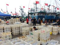 Citizens buy various kinds of seafood unloaded at Jimiya fishing Port in the West Coast New Area in Qingdao, China, on September 18, 2024. (