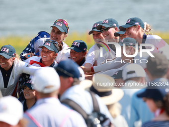 GAINESVILLE, VIRGINIA - SEPTEMBER 15: Team USA poses with the trophy after a Team USA win at the conclusion of the Solheim Cup at Robert Tre...