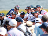 GAINESVILLE, VIRGINIA - SEPTEMBER 15: Team USA poses with the trophy after a Team USA win at the conclusion of the Solheim Cup at Robert Tre...