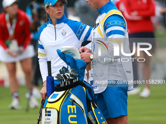 GAINESVILLE, VIRGINIA - SEPTEMBER 13: Linn Grant of Team Europe interacts with her caddy on the third green during Foursome Matches on Day O...