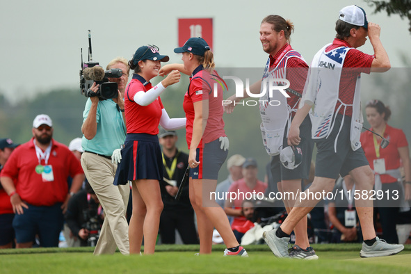 GAINESVILLE, VIRGINIA - SEPTEMBER 13: Rose Zhang of the United States (L) celebrates her winning putt on the 16th green with teammate Lauren...