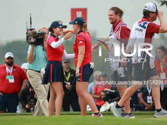 GAINESVILLE, VIRGINIA - SEPTEMBER 13: Rose Zhang of the United States (L) celebrates her winning putt on the 16th green with teammate Lauren...