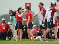 GAINESVILLE, VIRGINIA - SEPTEMBER 13: Rose Zhang of the United States (L) celebrates her winning putt on the 16th green with teammate Lauren...