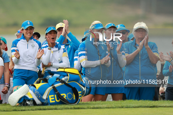 GAINESVILLE, VIRGINIA - SEPTEMBER 13: Some members of Team Europe cheer at the 16th green after Emily Kristine Pedersen’s putt during Fourso...