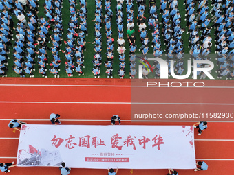 Prosecutors organize a ''9.18'' patriotic education activity on the campus of No. 1 Middle School in Lianyungang, China, on September 18, 20...