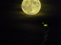 A partial lunar eclipse and supermoon occur in New York, United States, on September 17, 2024, as captured from Liberty Park in New Jersey....