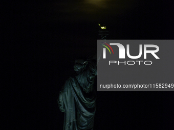 A partial lunar eclipse and supermoon occur in New York, United States, on September 17, 2024, as captured from Liberty Park in New Jersey....