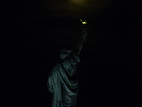 A partial lunar eclipse and supermoon occur in New York, United States, on September 17, 2024, as captured from Liberty Park in New Jersey....